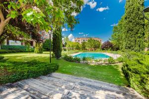 an image of a garden with a swimming pool at Las Huertas - Modern Accommodation in Madrid Conde Orgaz in Madrid