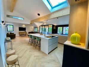 a kitchen with a large island and stools in a room at Cosy for You in Annecy