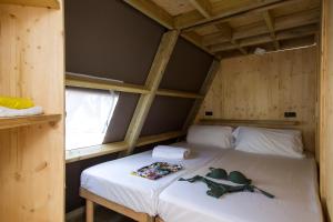 a bedroom with a bed in a wooden cabin at Tamarit Beach Resort in Tamarit