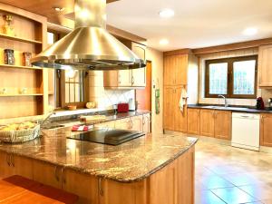 a kitchen with a large island in the middle at Chalet Can Singala in Port de Pollensa