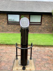 a black pole in front of a brick house at Holiday Inn Dover, an IHG Hotel in Dover