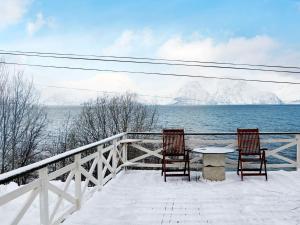 two chairs and a table on a balcony overlooking the water at 6 person holiday home in Olderdalen in Olderdalen