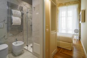 a bathroom with a shower and a toilet and a sink at Boutique Hotel Carlo Felice in Cagliari
