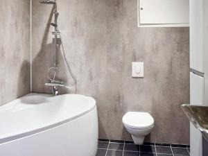 a bathroom with a white toilet and a sink at 8 person holiday home in VATNE in Vatne +26 photos