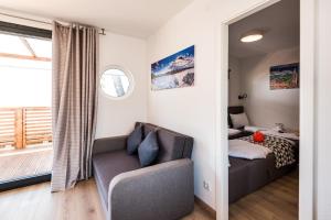 a living room with a couch and a bed at Mobile Home Vodice 14 in Vodice