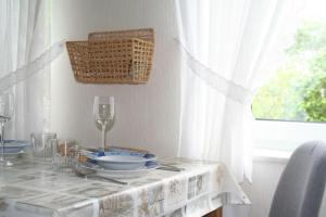 a table with a white table cloth on a table with glasses at Wohnung-Krabbe in Süderende