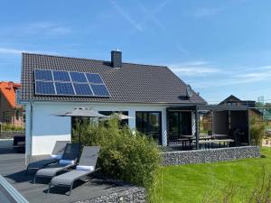 a house with solar panels on the roof at hey BEACHVILLA in Hohwacht