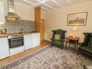 a kitchen with two chairs and a table at Kearton Shunner Fell in Richmond