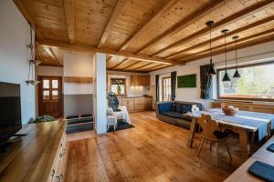 a kitchen and living room with a table and a dining room at Apartment Judith - Gallhof in Vollan