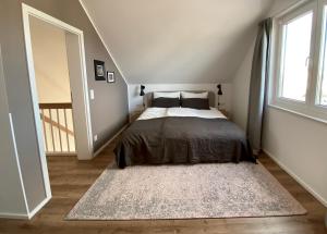 a bedroom with a bed and a large rug at hey BEACHVILLA in Hohwacht +32 photos