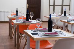 a group of tables with wine bottles on them at Casa del Cura in Las Navas del Marqués