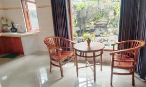 a dining room with a table and two chairs at TRESNA HOMESTAY in Ubud +27 photos