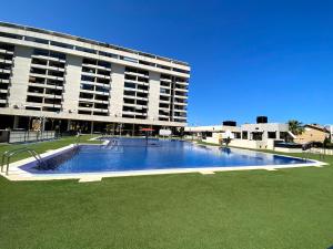 a large swimming pool in front of a building at M & B Beach Apartment in Valencia