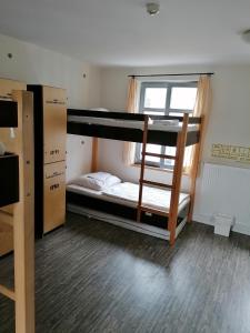 a room with two bunk beds and a window at Backpackers St. Pauli in Hamburg