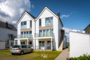 a house with a car parked in front of it at Antje in Olpenitz