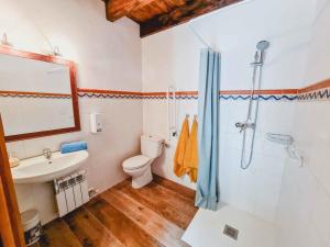 a bathroom with a toilet and a sink and a shower at El Molino de la Pastora in Valacloche +15 photos