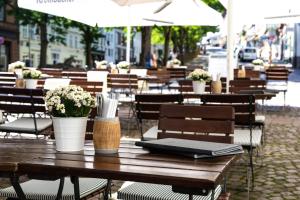 a wooden table with a laptop on top of it at Gartenlaube Marburg in Marburg an der Lahn