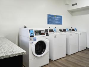 a washing machine and a washer and dryer in a room at stayAPT Suites Chattanooga-Ooltewah/VW in Ooltewah
