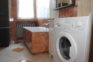 a kitchen with a washing machine and a sink at Travel Apartament Cracow in Kraków