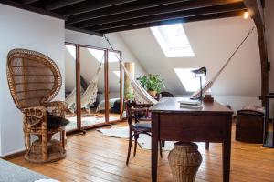an attic room with a desk and a chair at PAKHUIS in Ghent