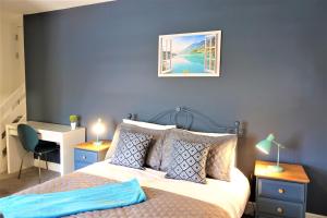 a bedroom with a bed and a desk with a desk at BrickSage Rooms, King's Lynn South Gate in King's Lynn