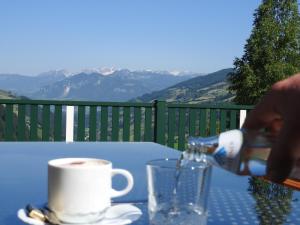 a person pouring coffee into a cup on a table at Ertlschweigerhaus Pension - Appartements - Zimmer in Donnersbach