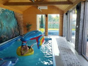 a man in a pool in a house at Willa Myśliwska dom 10-osobowy ZE STREFĄ BASENOWĄ w miejscowości Chocznia NIEDALEKO ZATORU I ENERGYLANDII in Wadowice