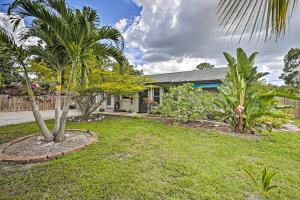 a house with palm trees in a yard at Boho-Style Escape with Patio about 3 Mi to Bonita Beach! in Bonita Springs