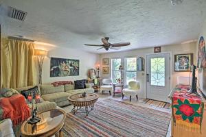 a living room with a couch and a table at Boho-Style Escape with Patio about 3 Mi to Bonita Beach! in Bonita Springs