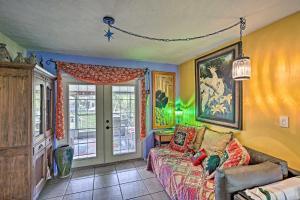 a living room with a couch and a window at Boho-Style Escape with Patio about 3 Mi to Bonita Beach! in Bonita Springs