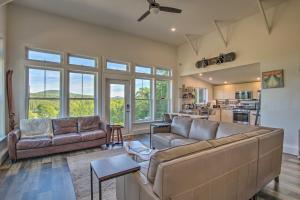 a living room with two couches and a kitchen at Cozy Bethel Escape with Views Less Than 10 Mi to Ski! in Bethel