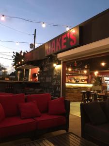 a restaurant with a red couch sitting outside of it at Coconut Court Beach Hotel in Bridgetown