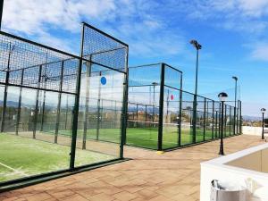 a tennis court with a net on a tennis court at Apartamento en Piles Playa in Piles