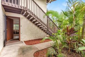 a staircase leading up to a house with palm trees at MAILAN HALE II in Kailua-Kona