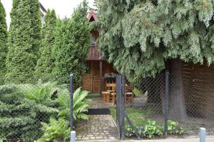 a fence in front of a garden with a building at Domki ogrzewane Sokół in Władysławowo +31 photos