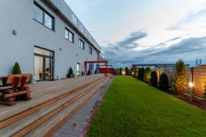 a wooden deck next to a building with a lawn at MOTEL S5 in Zbrachlin