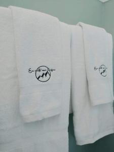 two white towels with two crosses on them at En route vers l’infini in Perce