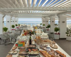 a buffet of food on a table with the ocean in the background at RH Bayren Hotel & Spa 4* Sup in Gandía