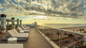 a balcony with chairs and a view of the beach at RH Bayren Hotel & Spa 4* Sup in Gandía