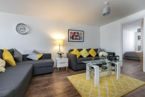 a living room with a couch and a table at KVM - City Apartments in Peterborough