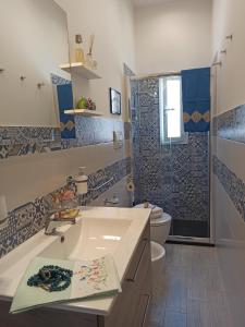 a bathroom with a tub and a sink and a toilet at House SoleSiculo in Siracusa
