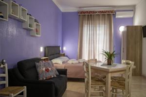 a living room with a bed and a couch and a table at Li Cumpari salentini in Lecce