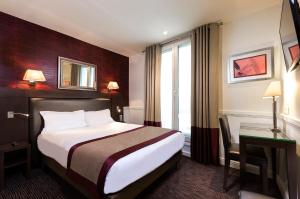 a hotel room with a bed and a window at Hôtel Elysées Flaubert in Paris