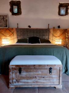 a bedroom with a bed with a trunk on it at Corral d'en Romagosa in Barcelona