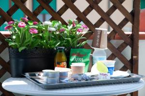 a tray of food on a table with flowers at Baron Beach Hotel in Scauri