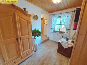 a room with a large wooden cabinet and a window at Haus Sandlweber by FiS - Fun in Styria in Bad Mitterndorf