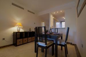a dining room with a blue table and chairs at CALANOVA Sea Golf Paradise in Mijas