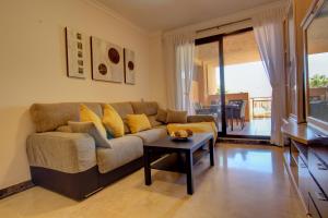 a living room with a couch and a table at CALANOVA Sea Golf Paradise in Mijas