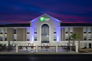 a hotel with a lit up building at night at Holiday Inn Express & Suites - Morehead City by IHG in Morehead City