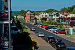 a city street with cars parked on the road at Kwatery Prywatne am Meer in Władysławowo